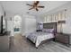 A comfortably furnished bedroom with hardwood floors leading to a well-appointed bathroom at 12439 Bristol Commons Cir, Tampa, FL 33626