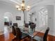 Dining room with hardwood floors, modern chandelier, and arched entryways to other rooms at 12439 Bristol Commons Cir, Tampa, FL 33626