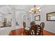 Well-lit dining room featuring hardwood floors, decorative chairs, and archways at 12439 Bristol Commons Cir, Tampa, FL 33626