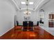 Bright dining room with modern glass table, hardwood floors, and view to adjacent rooms at 12439 Bristol Commons Cir, Tampa, FL 33626