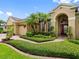 Close up of a home featuring a well-manicured lawn and mature landscaping at 12439 Bristol Commons Cir, Tampa, FL 33626