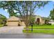 Charming home with a well-manicured lawn and a beautifully paved driveway at 12439 Bristol Commons Cir, Tampa, FL 33626