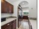Long kitchen view with stainless steel fridge, stove, backsplash and view to the backyard at 12439 Bristol Commons Cir, Tampa, FL 33626