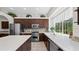 Spacious kitchen with stainless steel appliances, tile backsplash, and a bright window overlooking the yard at 12439 Bristol Commons Cir, Tampa, FL 33626