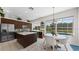 Large kitchen area with an island, stainless steel appliances, and dining area with views of the pool at 12439 Bristol Commons Cir, Tampa, FL 33626