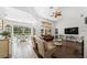 Large living room features tiled floors, a ceiling fan and overlooks the backyard at 12439 Bristol Commons Cir, Tampa, FL 33626