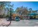 Community playground with multiple slides, climbing structures and shaded areas at 12439 Bristol Commons Cir, Tampa, FL 33626