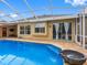 Pool view with a screened enclosure and view of the home's exterior at 12439 Bristol Commons Cir, Tampa, FL 33626