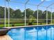 Serene pool featuring a water fountain and lush greenery in the backyard at 12439 Bristol Commons Cir, Tampa, FL 33626