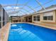 Stunning backyard pool area with a screened enclosure and view of the home at 12439 Bristol Commons Cir, Tampa, FL 33626