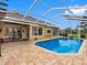Inviting backyard pool featuring brick paving and a screened enclosure at 12439 Bristol Commons Cir, Tampa, FL 33626