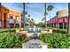 A peaceful view of Westchase Town Center, with a fountain, shops, and palm trees under a clear blue sky at 12439 Bristol Commons Cir, Tampa, FL 33626