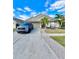 Charming single-story home featuring mature landscaping, a two-car garage, and a well-manicured lawn at 12603 Midpointe, Riverview, FL 33578
