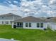 This home features a well-maintained backyard with lush green grass and a covered patio, perfect for enjoying the outdoors at 13105 Fruitville Way, Riverview, FL 33579