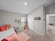 Cozy bedroom featuring a comfortable bed, carpet floors, and natural light from the window at 13105 Fruitville Way, Riverview, FL 33579