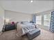Bright bedroom with soft carpet floors and natural light streaming in from the windows at 13105 Fruitville Way, Riverview, FL 33579