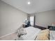 Comfortable bedroom featuring a bed, sofa, desk, and soft carpet floors at 13105 Fruitville Way, Riverview, FL 33579