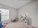Bright room with a small table, a large window, and storage for toys and books at 13105 Fruitville Way, Riverview, FL 33579
