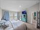 Spacious bedroom with large windows, soft carpet floors, and a TV at 13105 Fruitville Way, Riverview, FL 33579