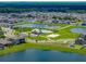 Aerial view of community pool, clubhouse, and neighborhood lakes in a Gathering-friendly community at 13105 Fruitville Way, Riverview, FL 33579
