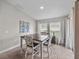 Cozy dining room features natural light from two windows and a sliding door with backyard views at 13105 Fruitville Way, Riverview, FL 33579