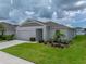 Beautiful home featuring manicured landscaping and a spacious two-car garage at 13105 Fruitville Way, Riverview, FL 33579