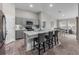 The kitchen features gray cabinets, quartz countertops, a kitchen island with bar stools and an adjacent dining area at 13105 Fruitville Way, Riverview, FL 33579
