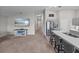 View of an open floor plan, showcasing the TV room, kitchen with an island, and hallway leading to the bedrooms at 13105 Fruitville Way, Riverview, FL 33579