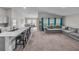 Open-concept living area connecting kitchen, dining, and seating with abundant natural light at 13105 Fruitville Way, Riverview, FL 33579