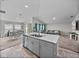 The seamless connection showcases the kitchen island flowing into the Gathering room and dining room at 13105 Fruitville Way, Riverview, FL 33579
