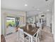 Open concept living space with stainless steel appliances, a modern island, and access to a backyard patio at 13105 Fruitville Way, Riverview, FL 33579