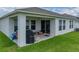 Covered patio with ample space for outdoor seating and grilling, perfect for relaxing and entertaining at 13105 Fruitville Way, Riverview, FL 33579