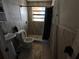 Bathroom featuring a shower, toilet, sink, medicine cabinet, and bright window at 13710 Frances Ave, Hudson, FL 34667