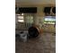 Vacant living room featuring two bright windows and a large construction fan at 13710 Frances Ave, Hudson, FL 34667