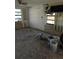 Vacant living room with exposed walls and two windows allowing plenty of natural light at 13710 Frances Ave, Hudson, FL 34667