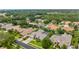 An aerial view of beautiful homes in a desirable neighborhood with mature trees and well-maintained landscaping at 1553 Canopy Oaks Blvd, Palm Harbor, FL 34683