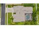 Aerial view of property showcasing the expansive roof, screened pool, and lush landscaping at 1553 Canopy Oaks Blvd, Palm Harbor, FL 34683