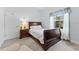 Comfortable bedroom boasts natural light, a wood sleigh bed, and neutral tones at 1553 Canopy Oaks Blvd, Palm Harbor, FL 34683