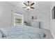 Bedroom featuring natural light, stylish decor, and a ceiling fan at 1553 Canopy Oaks Blvd, Palm Harbor, FL 34683