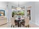 Cozy dining area with a view of the pool, featuring stylish furnishings perfect for Gathering meals at 1553 Canopy Oaks Blvd, Palm Harbor, FL 34683