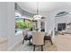 Inviting dining area bathed in natural light, offering views of the pool and manicured outdoor space at 1553 Canopy Oaks Blvd, Palm Harbor, FL 34683