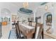 Open concept dining area with a large table, elegant chairs, and view into an adjoining living room at 1553 Canopy Oaks Blvd, Palm Harbor, FL 34683