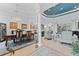 Elegant dining and living area with chandelier, column, blue accent paint and modern furniture at 1553 Canopy Oaks Blvd, Palm Harbor, FL 34683