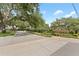 Manning Oaks community entrance featuring brick walls, mature trees, and lush landscaping at 1553 Canopy Oaks Blvd, Palm Harbor, FL 34683