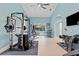 Home exercise room with weight training equipment and a view to the outdoor area and pool at 1553 Canopy Oaks Blvd, Palm Harbor, FL 34683