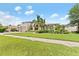 Charming two-story home with a lush, landscaped front yard and a symmetrical design at 1553 Canopy Oaks Blvd, Palm Harbor, FL 34683