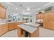 Open-concept kitchen with an island, ample cabinets, wine rack and modern appliances, ideal for cooking and gathering at 1553 Canopy Oaks Blvd, Palm Harbor, FL 34683