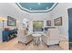 Comfortable living room featuring neutral-toned seating, stylish tables, and seamless flow into other living areas at 1553 Canopy Oaks Blvd, Palm Harbor, FL 34683