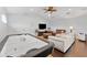 Spacious living area complete with sofas, TV, and air hockey table at 1553 Canopy Oaks Blvd, Palm Harbor, FL 34683