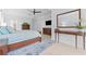 Main bedroom featuring a bed, dresser, ceiling fan, mirror, and access to the en suite bathroom at 1553 Canopy Oaks Blvd, Palm Harbor, FL 34683